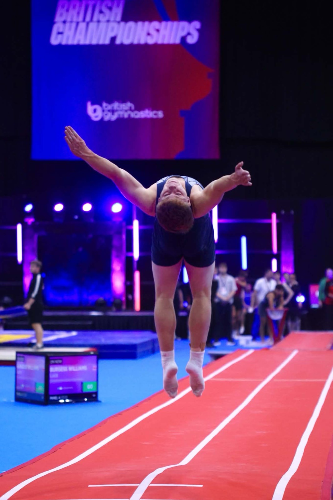 Sixth Former Luca mid-tumble above the red tumbling track at the British Championships