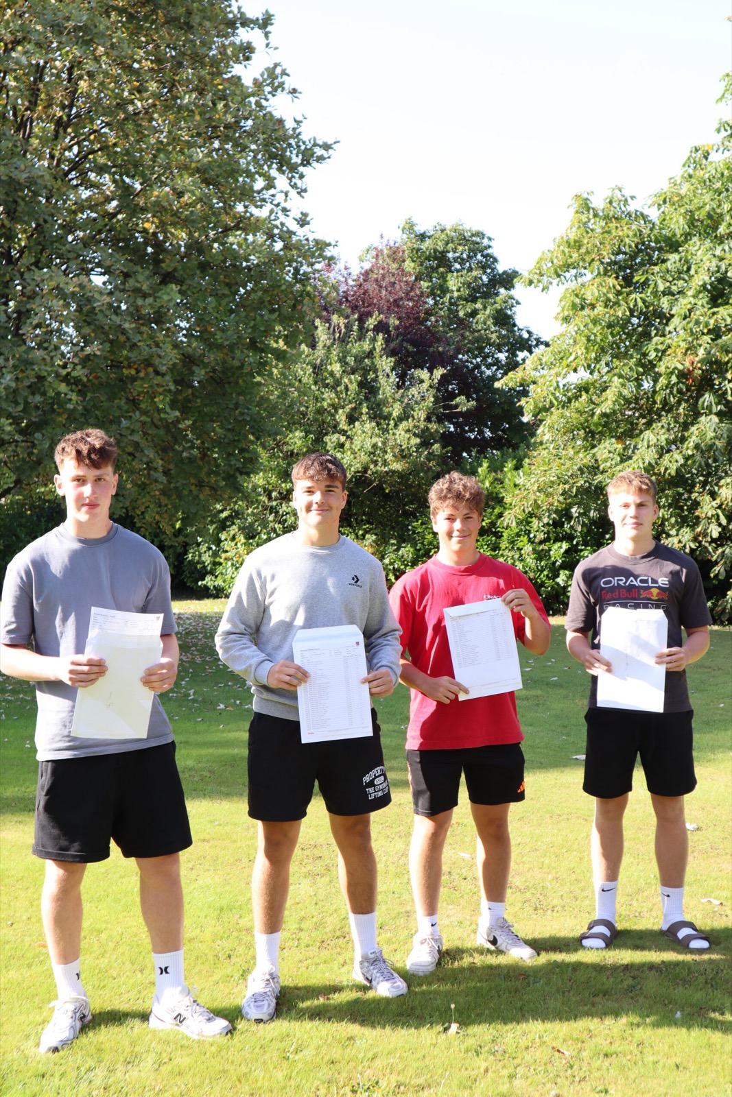 Boys holding their results letters