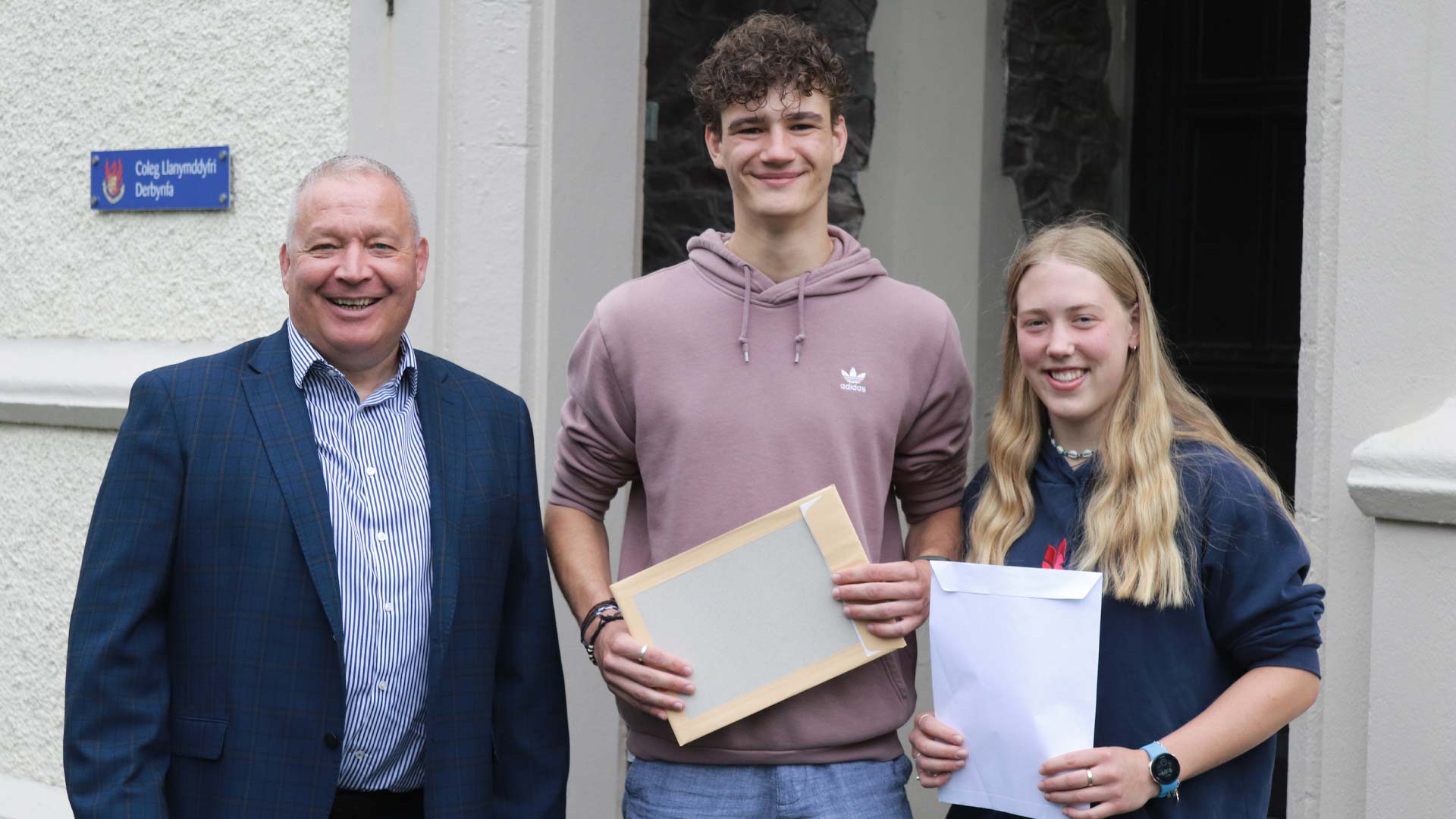 Students celebrating results with the Warden