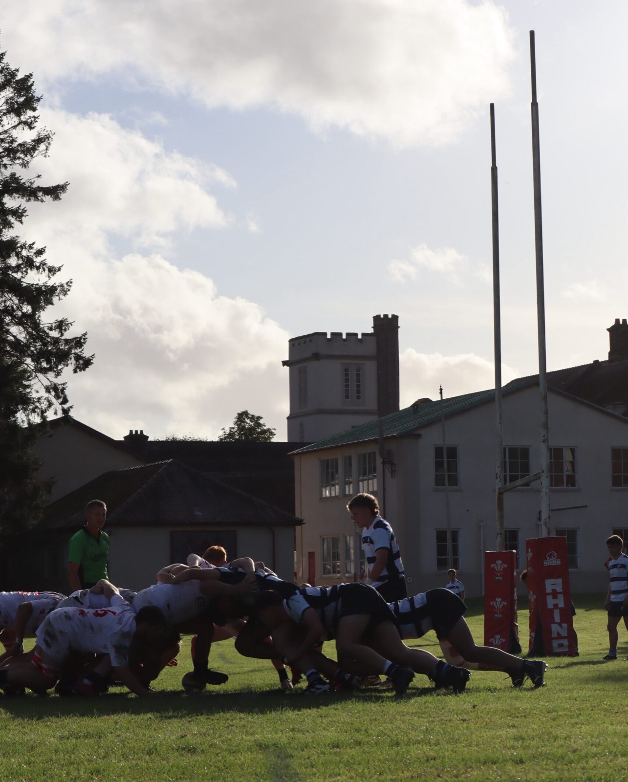 Rugby beneath the College tower at dusk