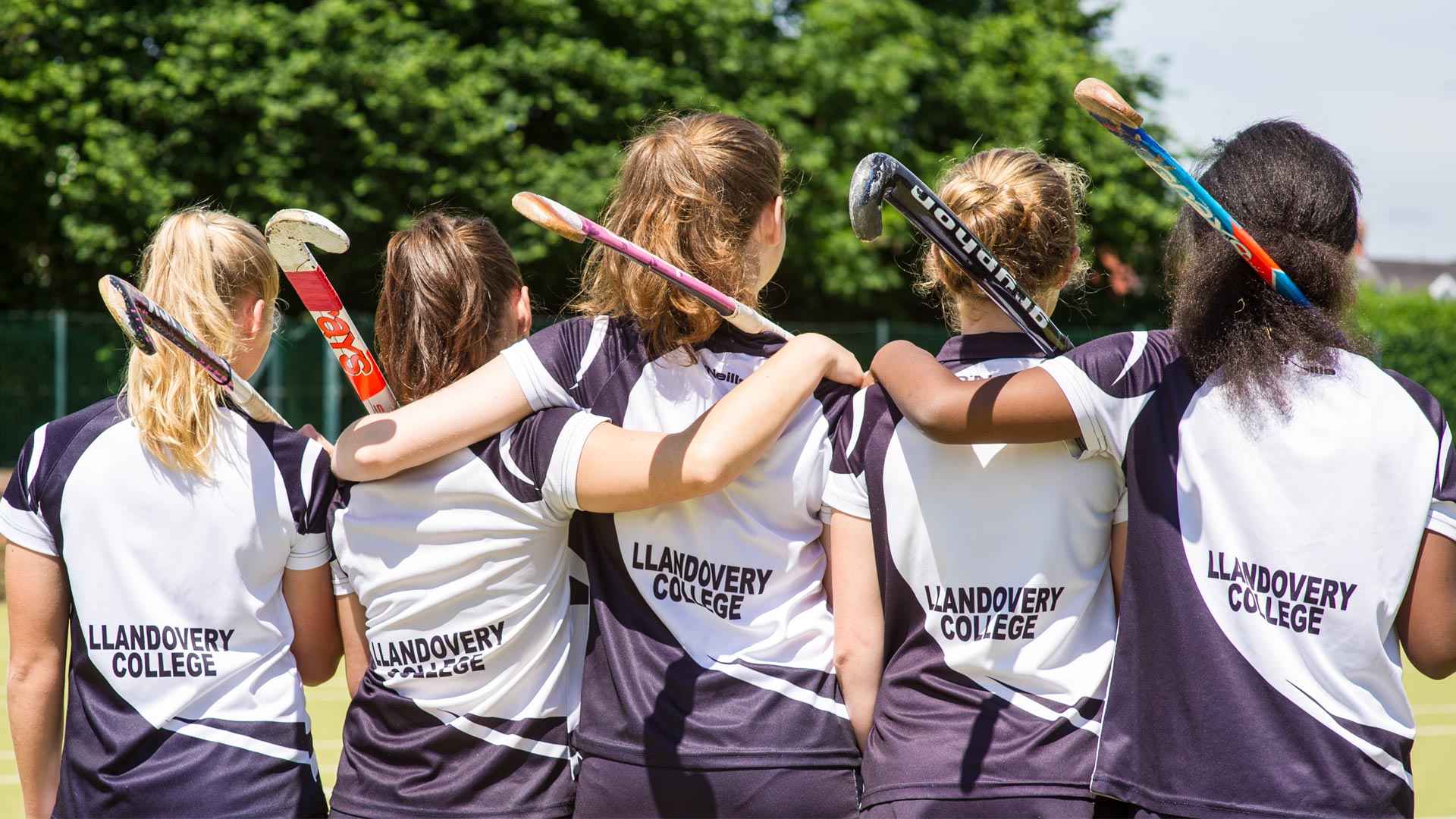 Llandovery College pupils arm in arm on the sports field